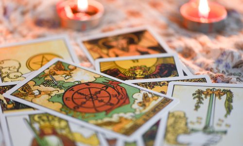 Tarot card with candlelight on the darkness background for Astrology Occult Magic illustration / Magic Spiritual Horoscopes and Palm reading fortune teller concept